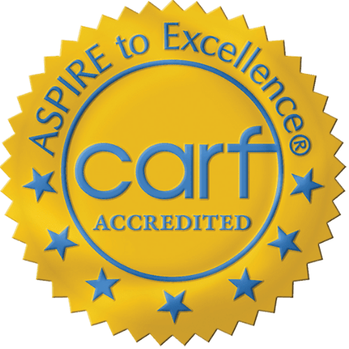 CARF Accredited seal: Yellow and blue, text “Aspire to Excellence” and “CARF Accredited”.