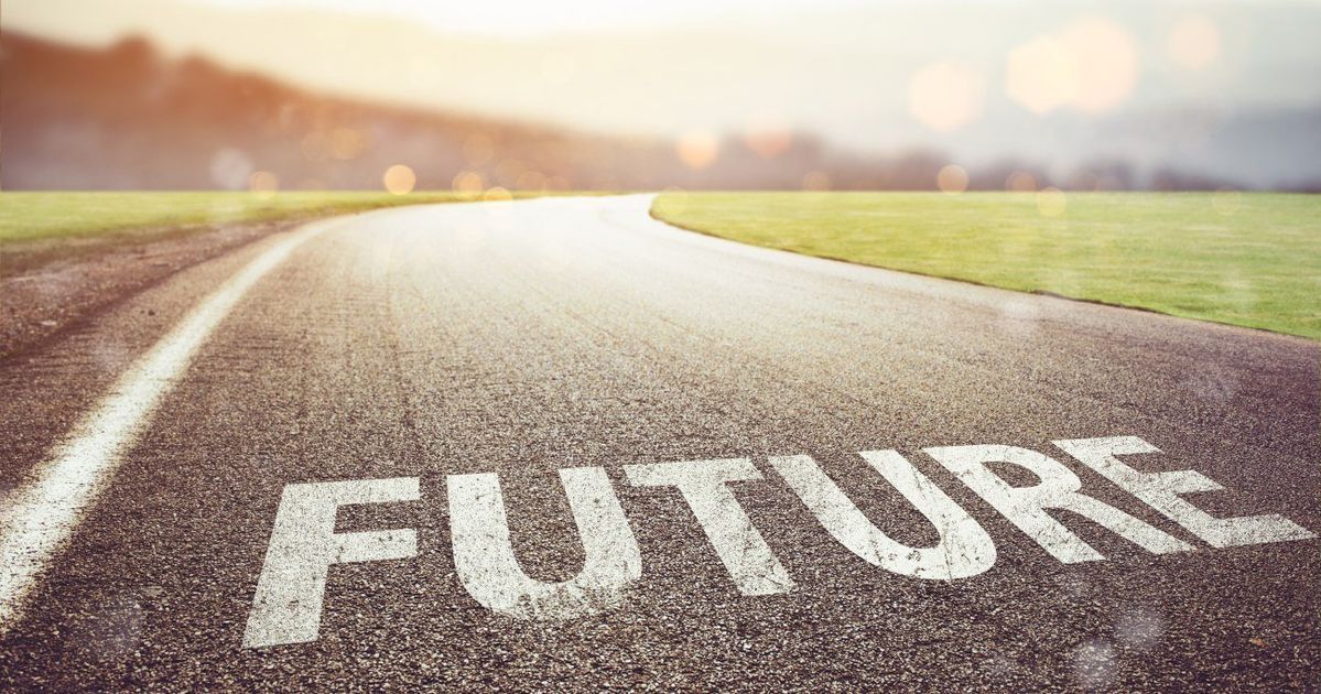 Road with “FUTURE” painted on it, curving toward a bright horizon