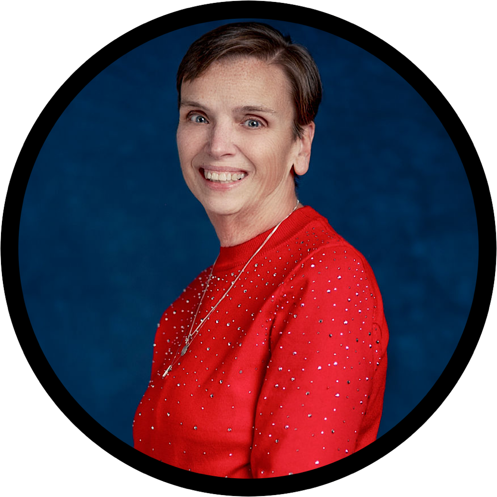 Studio portrait of a smiling person in a red top against a blue background