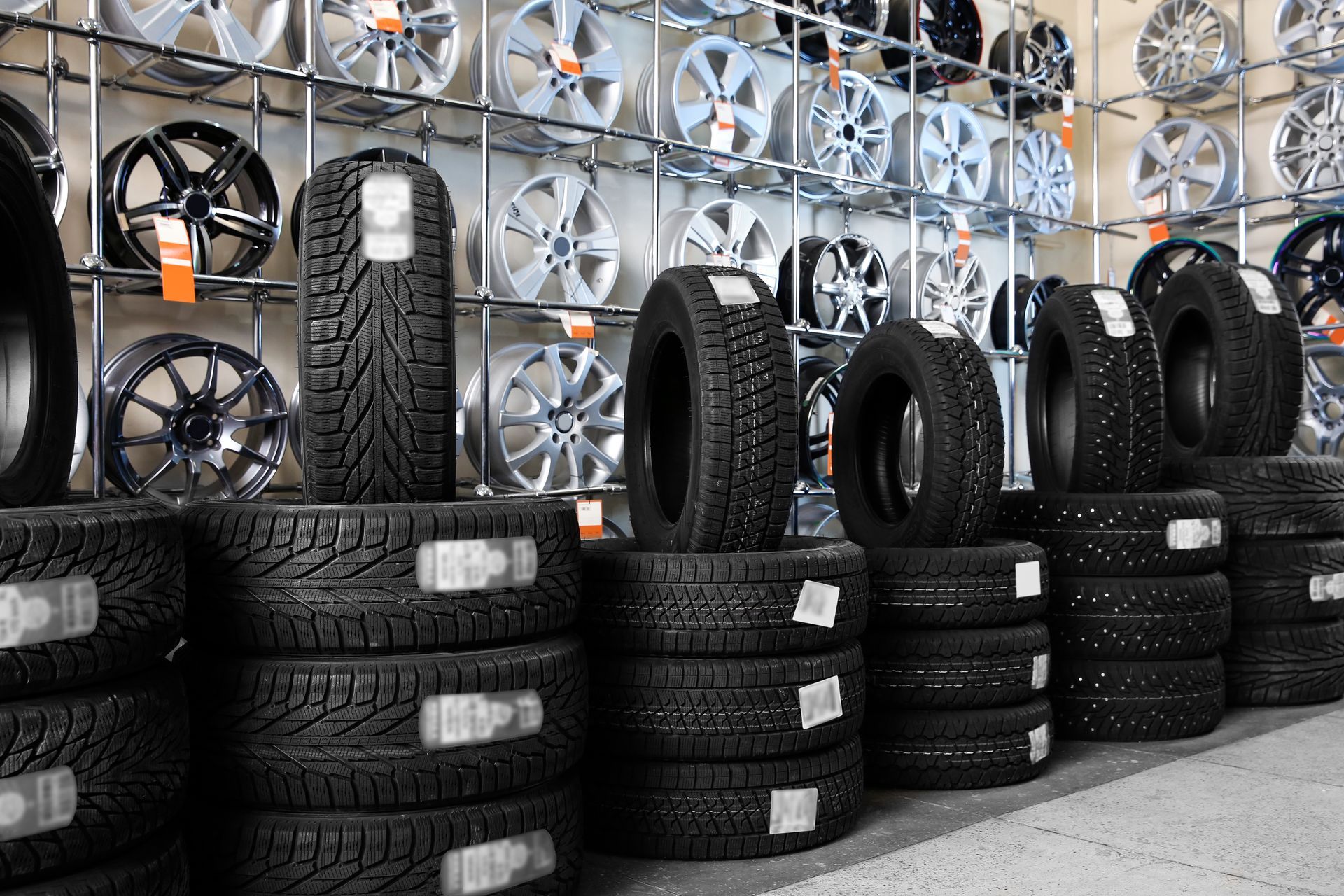 Car tires and alloy wheels at a tire shop. Car tires and alloy wheels at a tire shop.