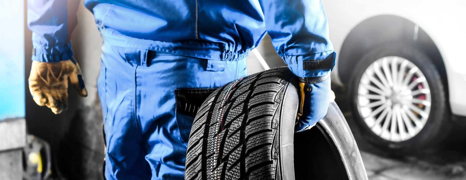 Mechanic holding a tire. — C.R. Smith Radiator & Auto Repair Mechanic holding a tire. — C.R. Smith Radiator & Auto Repair