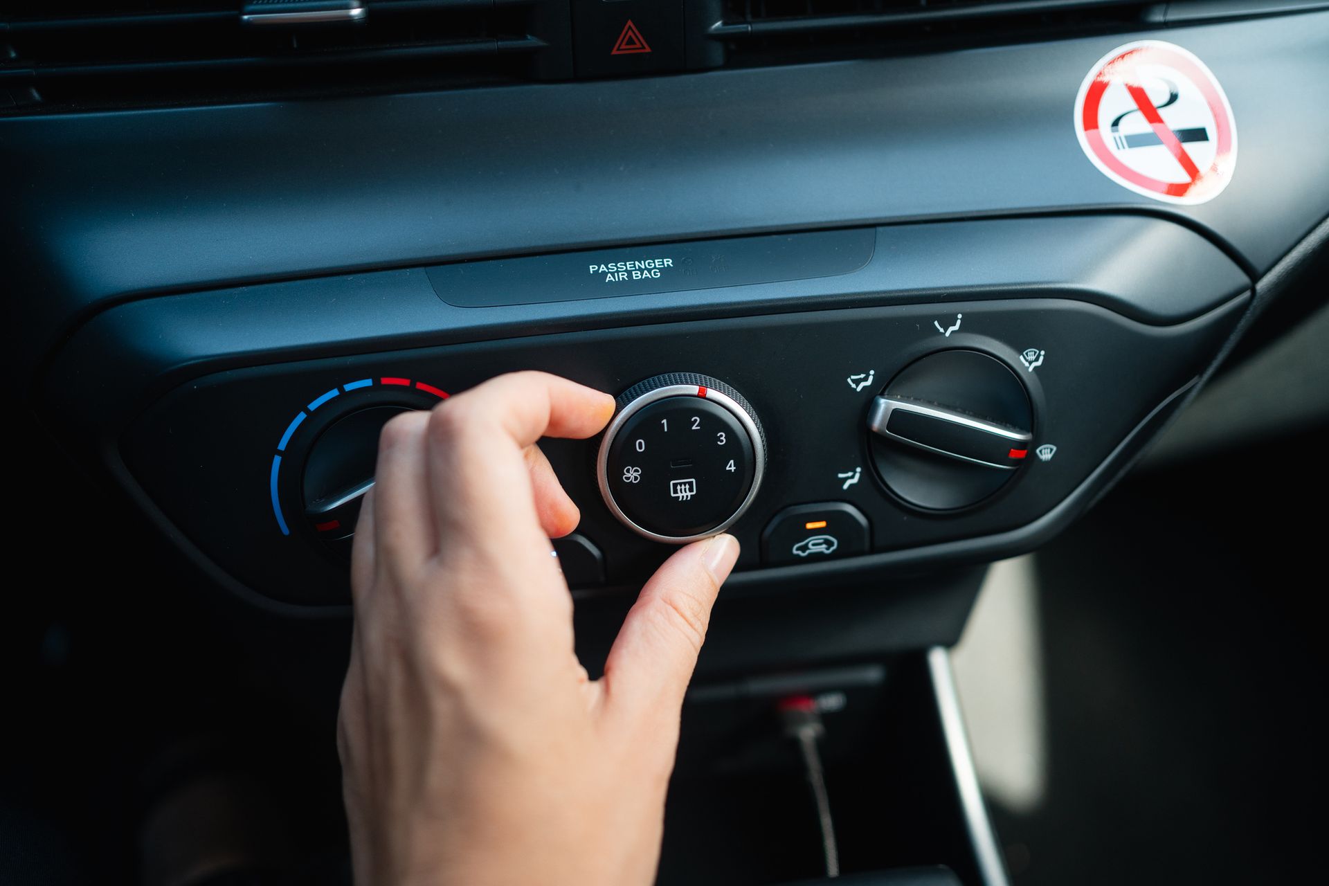 Turning on air conditioner in the car.