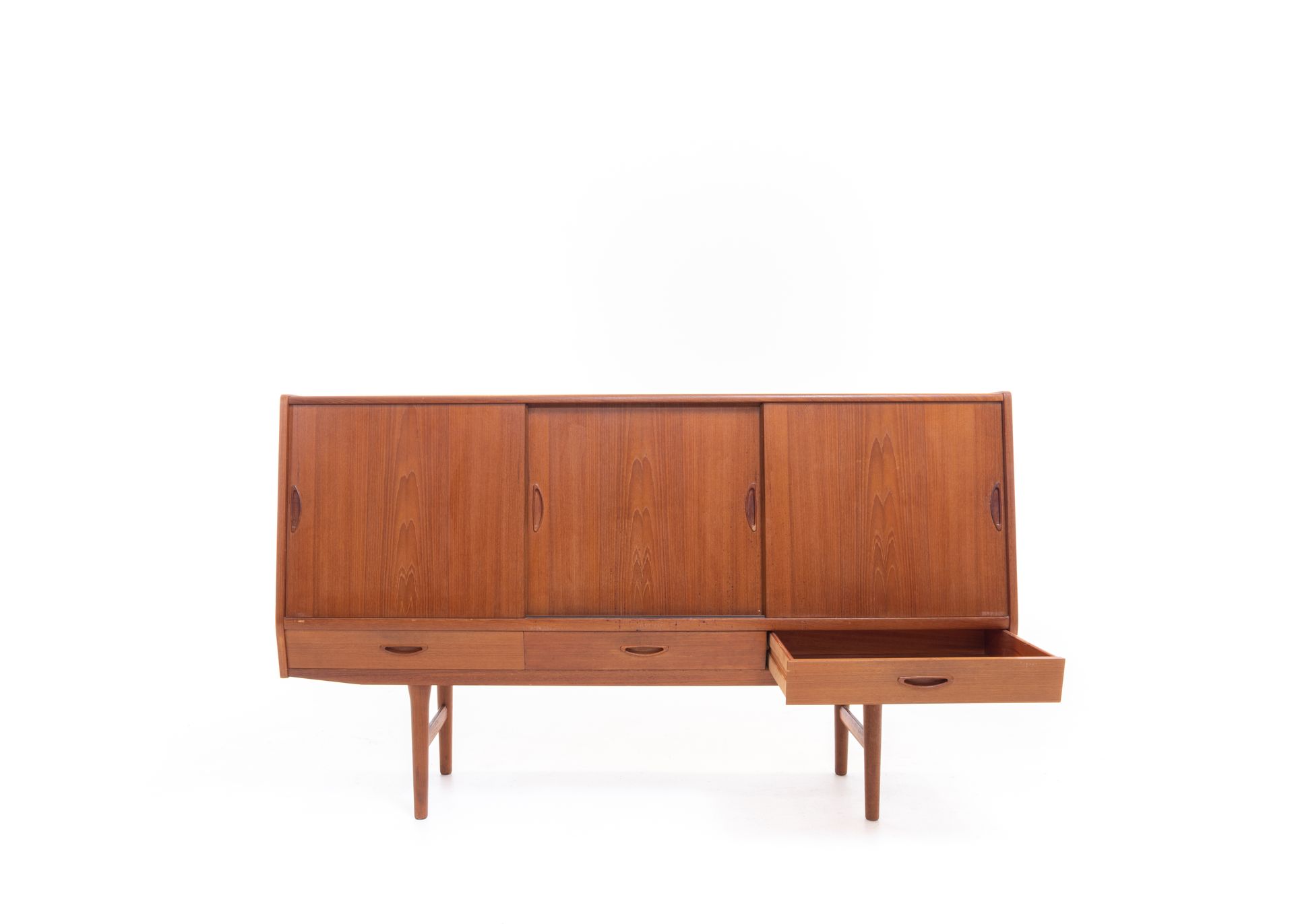 Mid-century modern teak credenza with sliding doors and three drawers, one open.