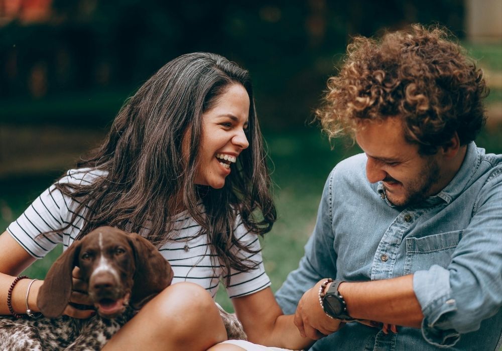 A happy man and woman sitting with a dog New Jersey mental health care