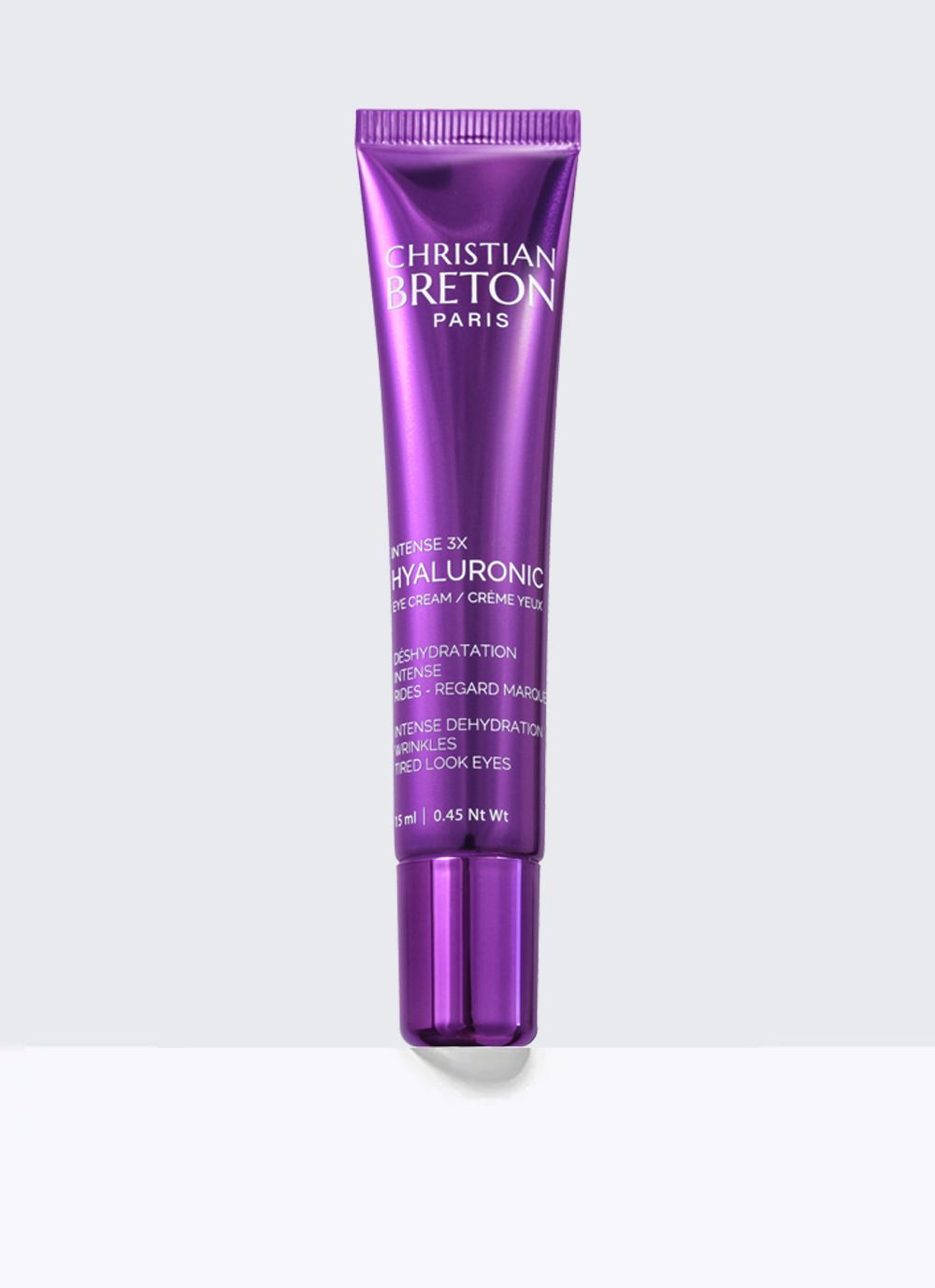 Un tubo morado de crema para ojos christian breton sobre un fondo blanco.