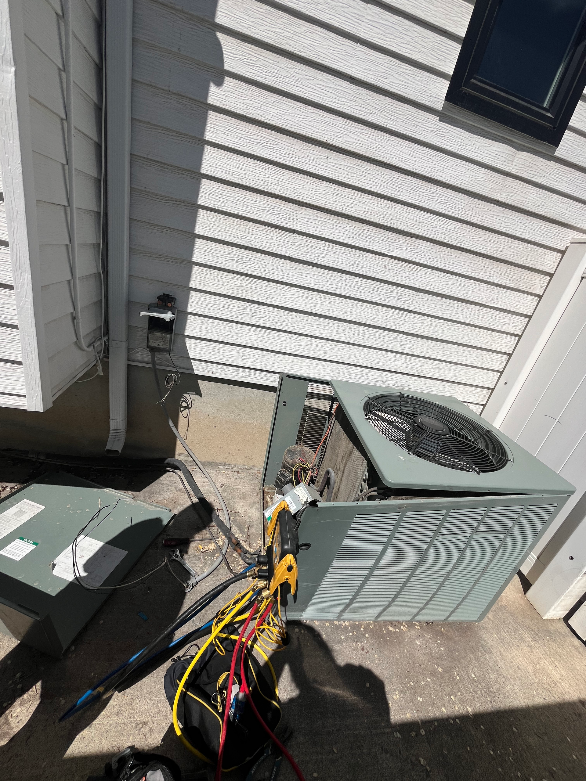 ac unit being serviced by henries heating and air in salt lake city