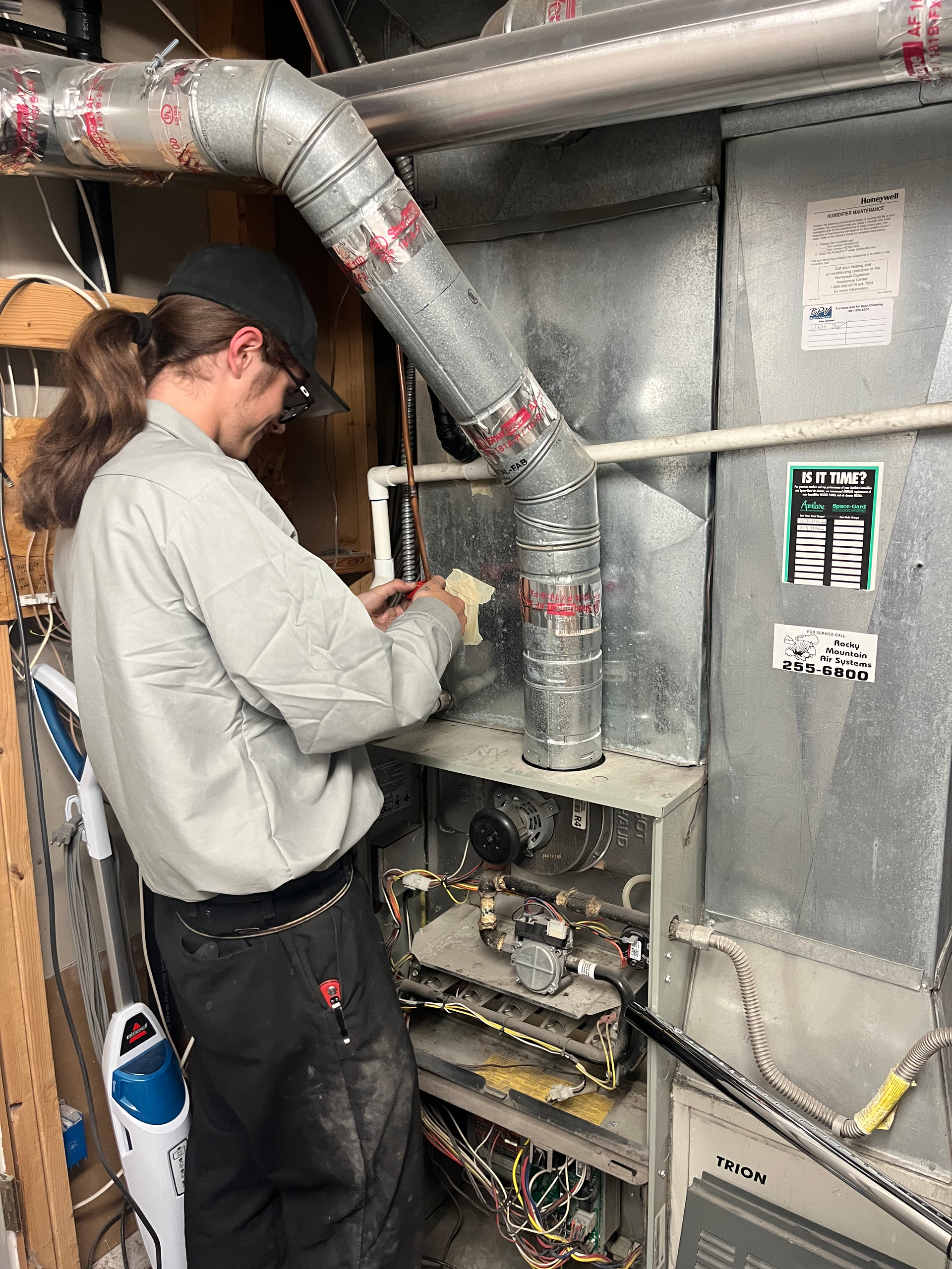 henries heating and air tech working on hvac system in salt lake city
