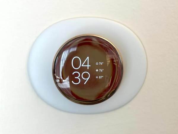 smart thermostat installed on a wall in a home