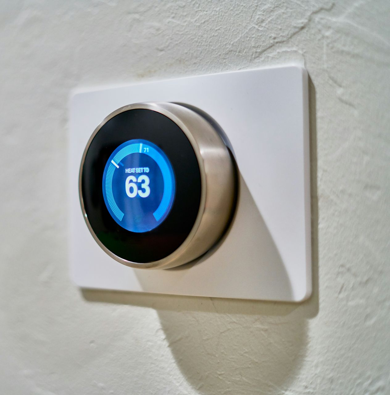 smart thermostat installed on the wall of a home