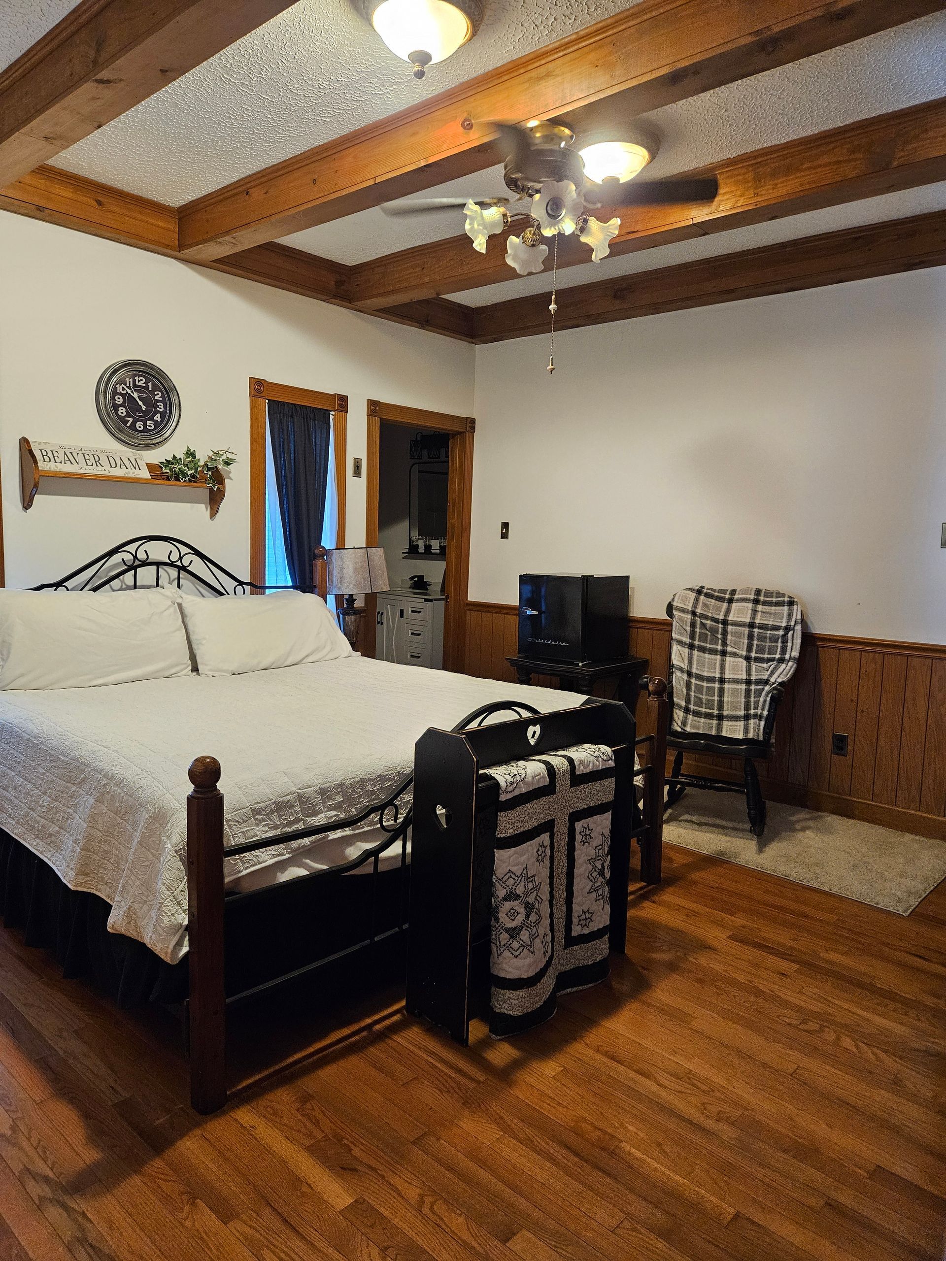A bedroom with a bed and a sign that says home