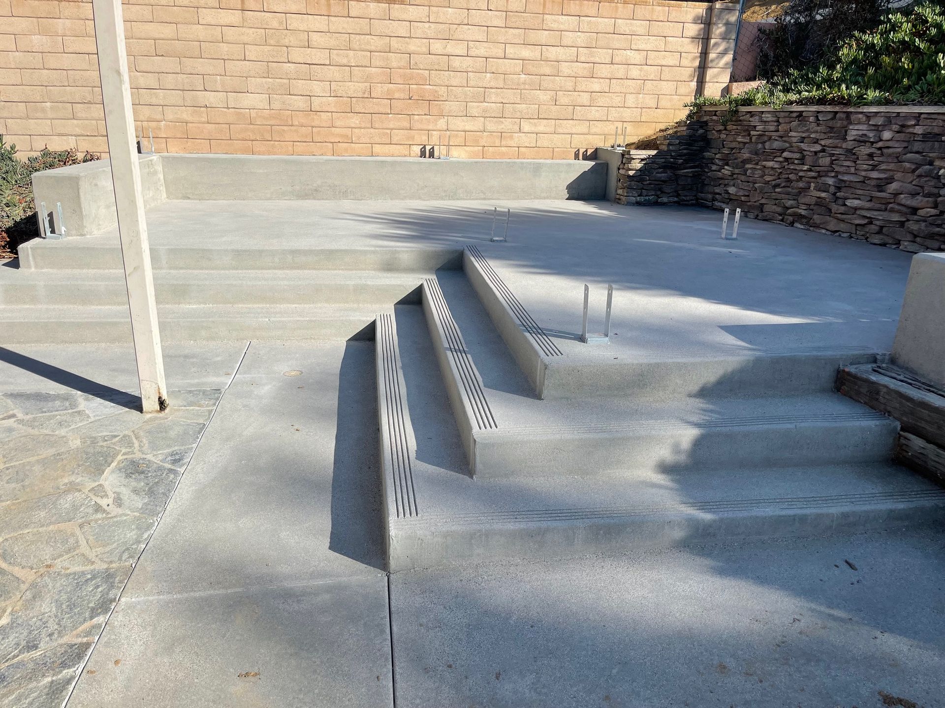 Concrete stairs and metal handrails leading up to a brick building entrance