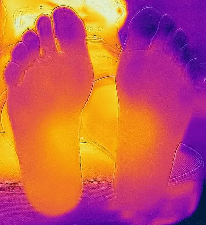 A close up of a person 's feet in a thermal image.