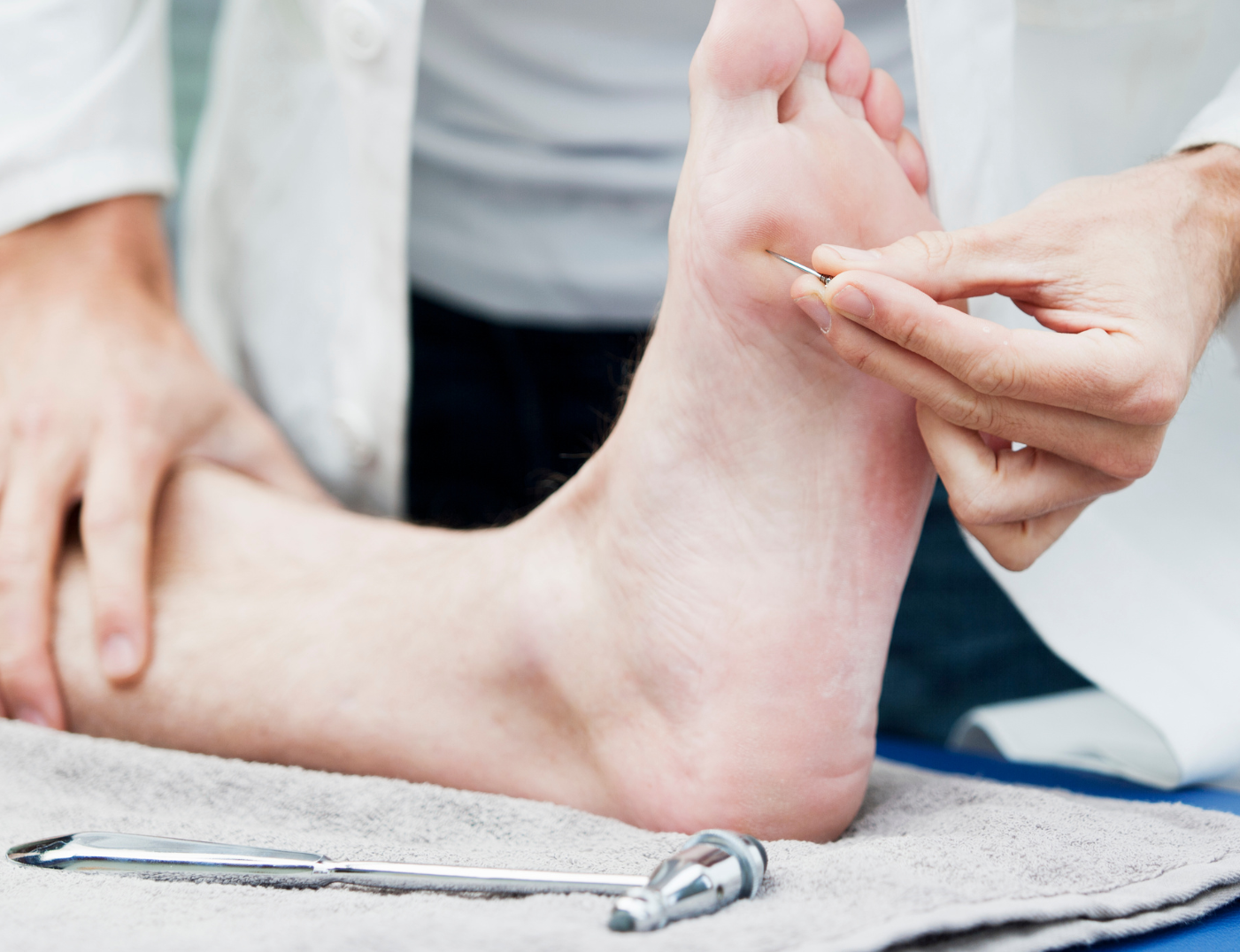A close up of a person 's foot being examined by a doctor