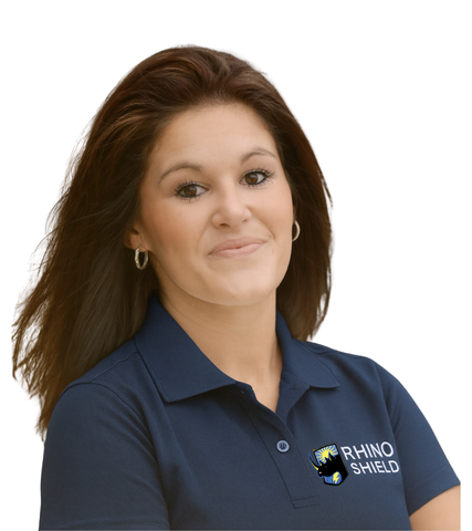 Smiling woman in navy Rhino Shield polo shirt on a white background