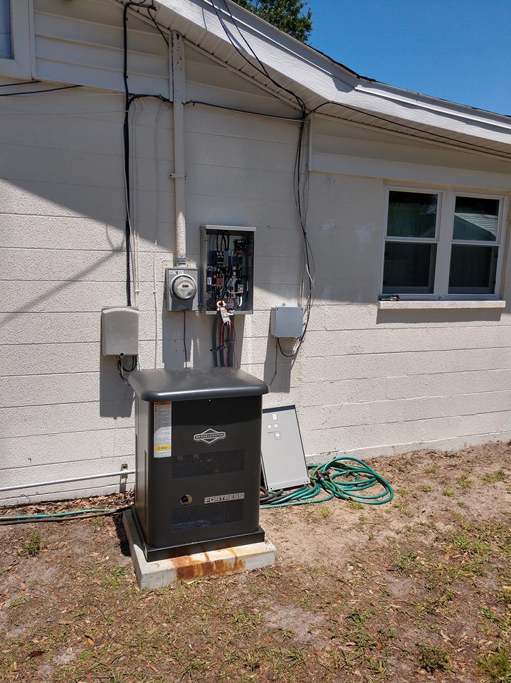 Exterior view of house with generator, electrical panel, and utility boxes.