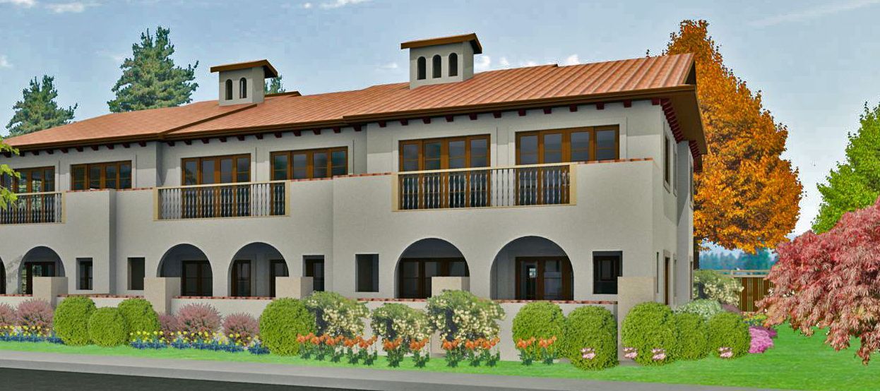 Historic stucco building with red tile roof, arched windows, and colorful gardens in front