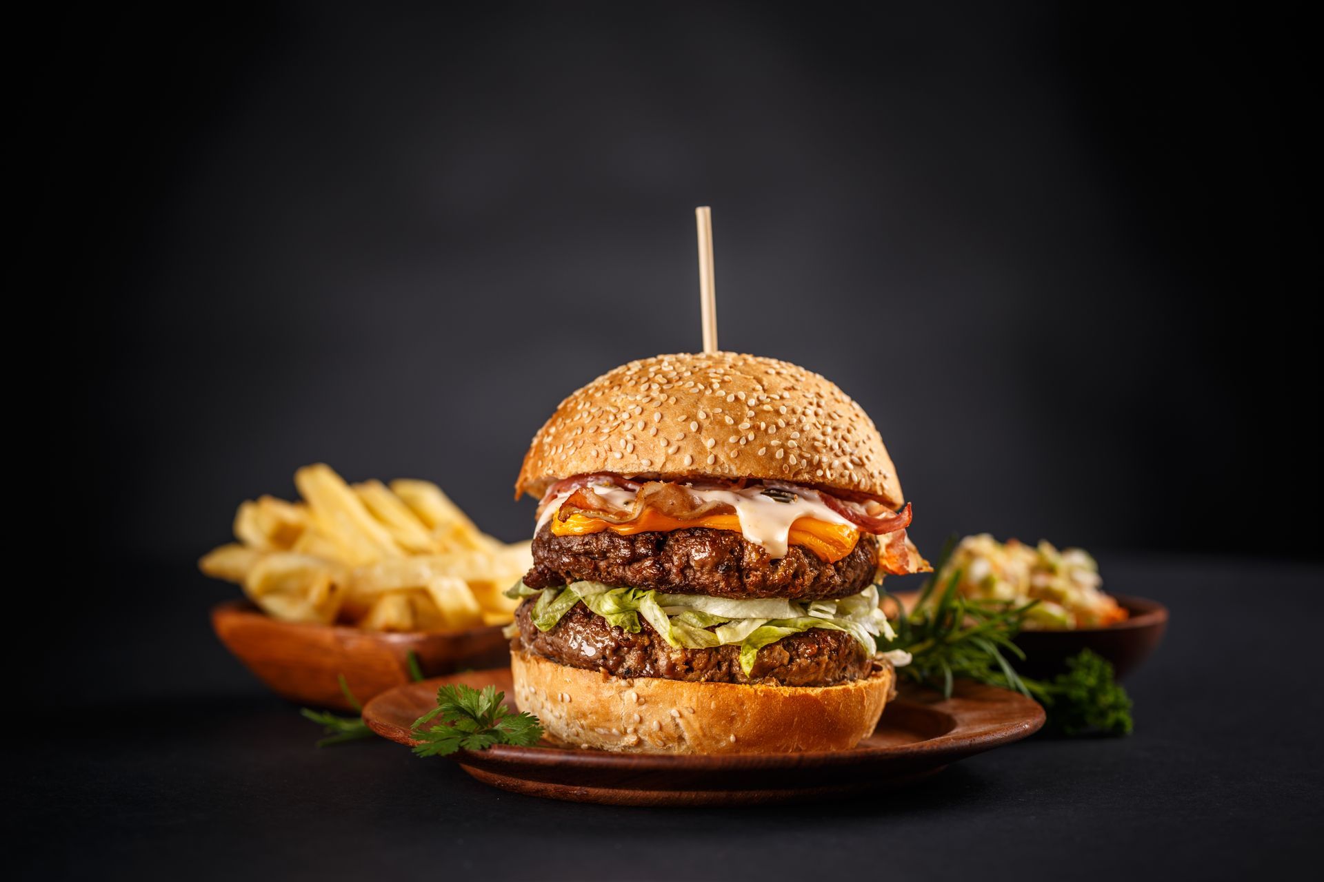 A hamburger and french fries on a plate on a table.