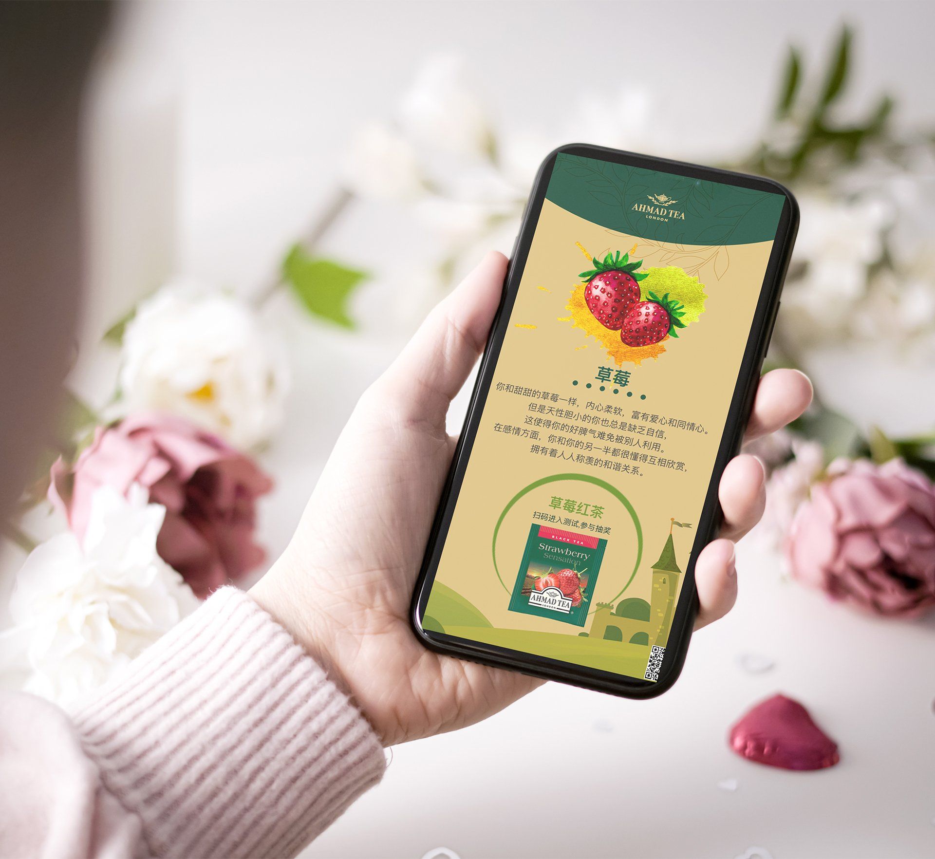 A person is holding a cell phone with a picture of strawberries on the screen.