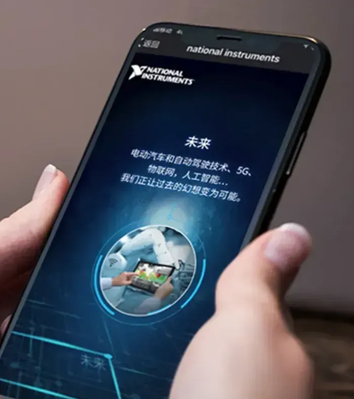 A person is holding a phone that says national instruments on the screen