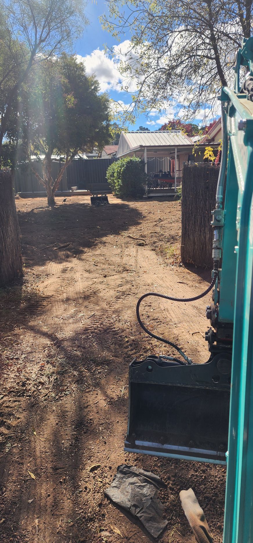 A White Fence with A Tree in Front of It — GnB Fencing and Excavation in Queanbeyan, NSW