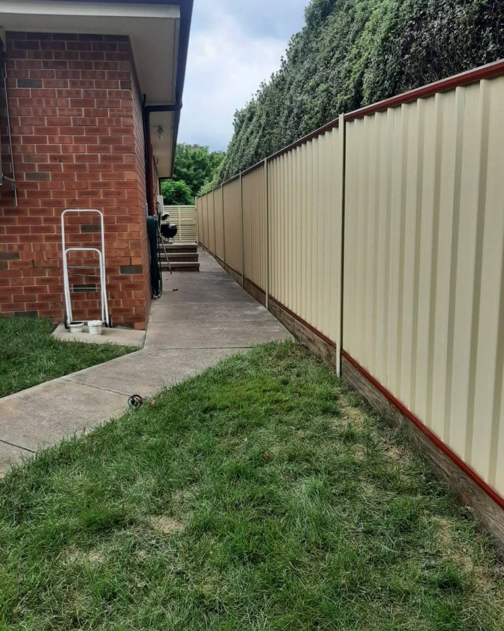 White Long Fence in The Backyard of A House — GnB Fencing and Excavation in Queanbeyan, NSW