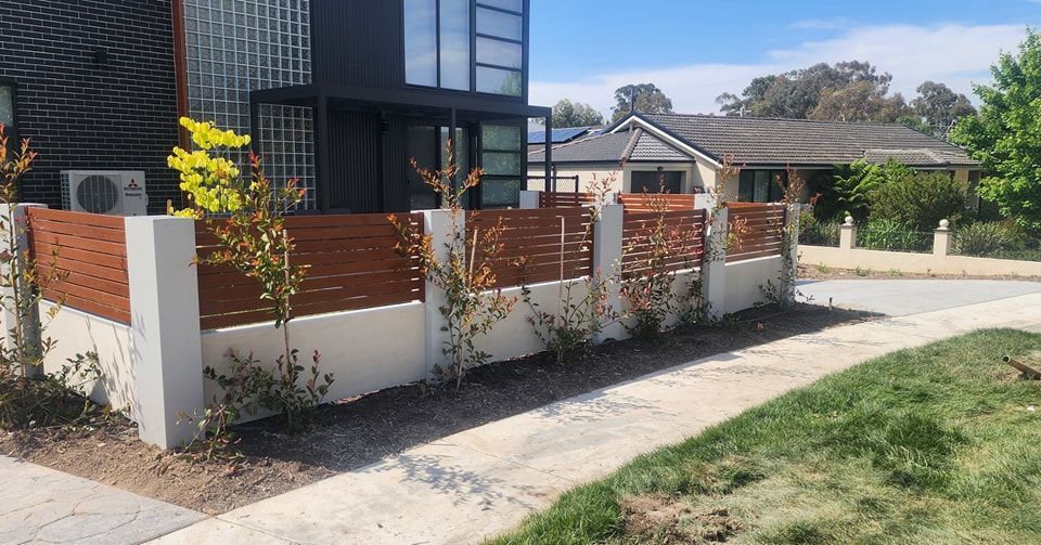 A House with A Wooden Styling Fence and A Sidewalk in Front of It  — GnB Fencing and Excavation in Queanbeyan, NSW