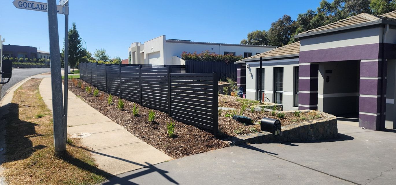 An aluminium slated fence in front of a house — GnB Fencing and Excavation in Queanbeyan, NSW