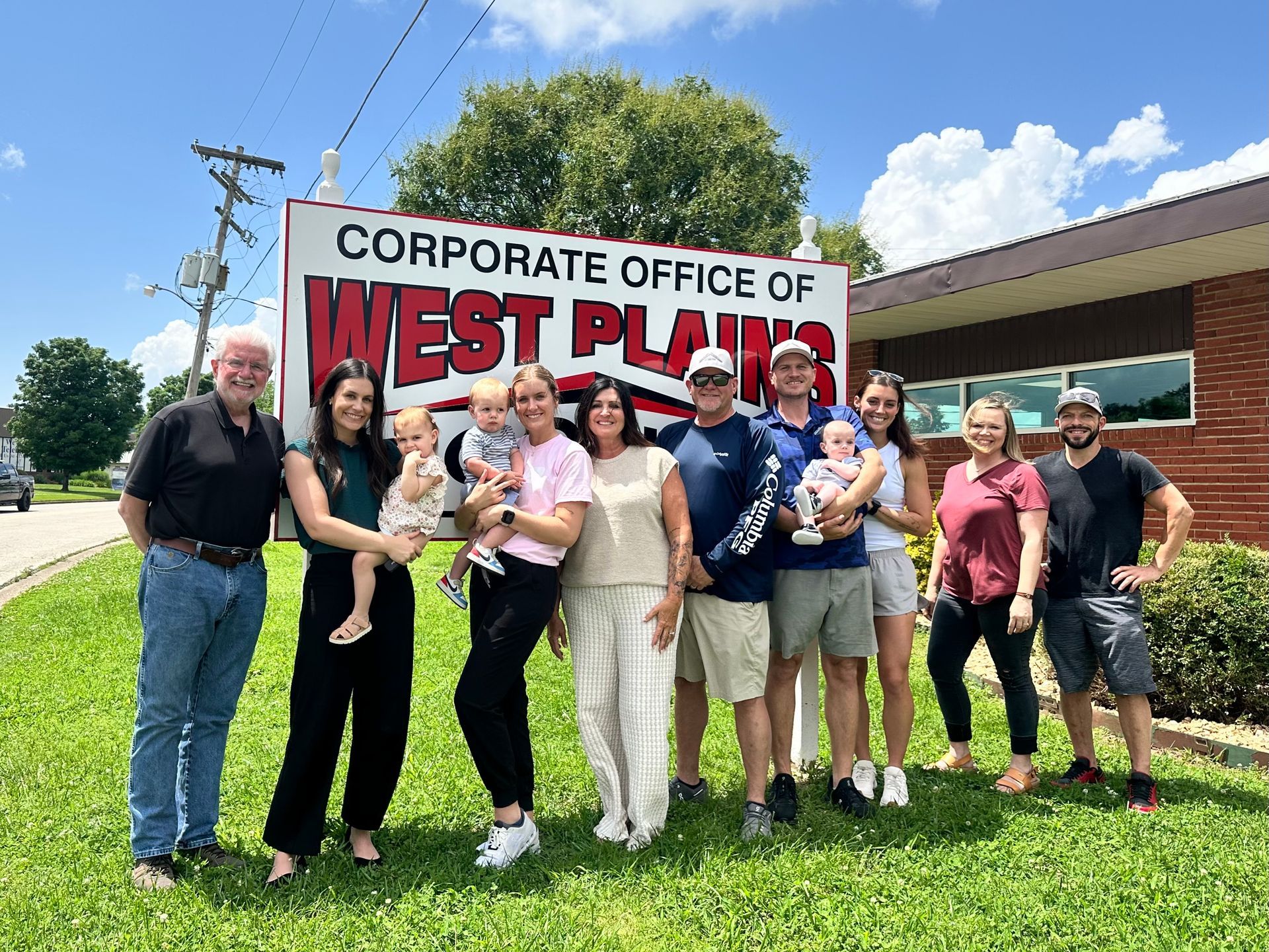 Group of people posing in front of a 