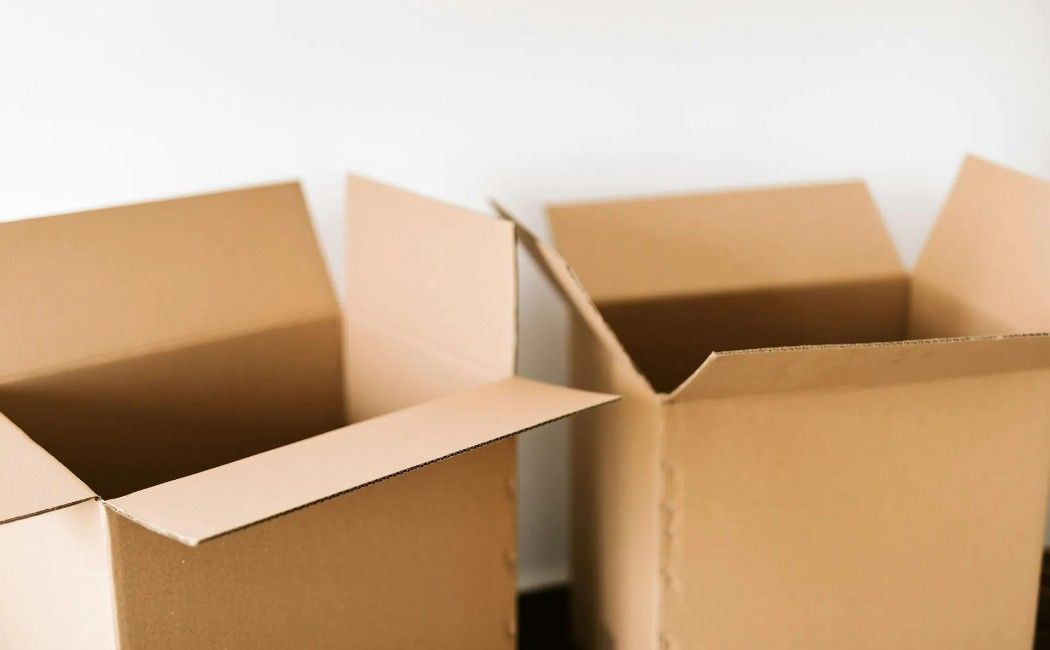 Several open brown cardboard boxes on a white background