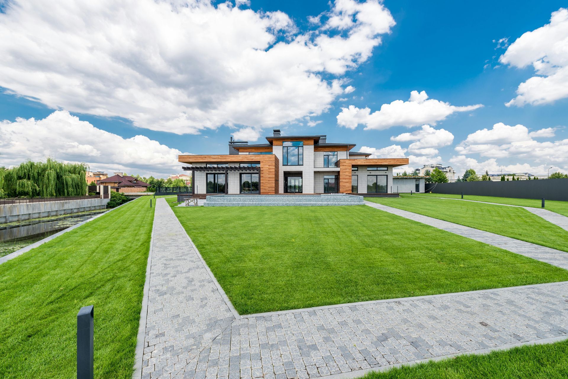 A large house with a large lawn in front of it.