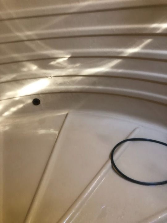 A White Pipe Is Hanging Inside Of A Water Tank — Alligator Water Tank Cleaning In Pomona, QLD