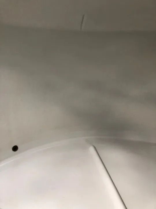 A Close Up Of A White Tank With A Hole In It — Alligator Water Tank Cleaning In Pomona, QLD