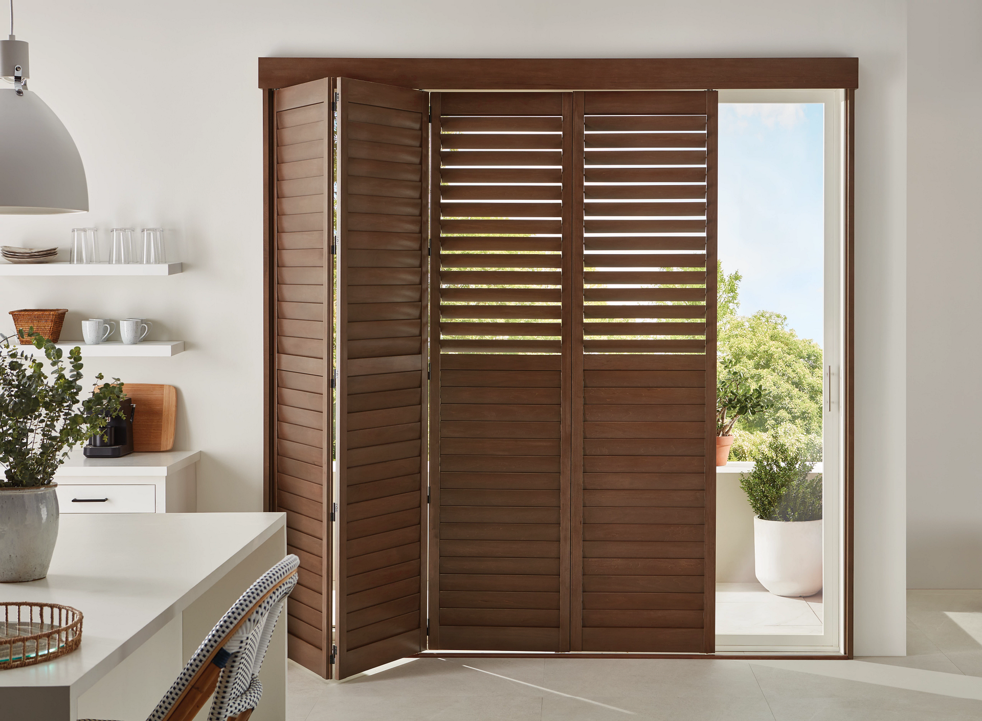 Heritance® Hardwood Shutters on a balcony door.