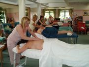 A group of people are getting a massage in a room.