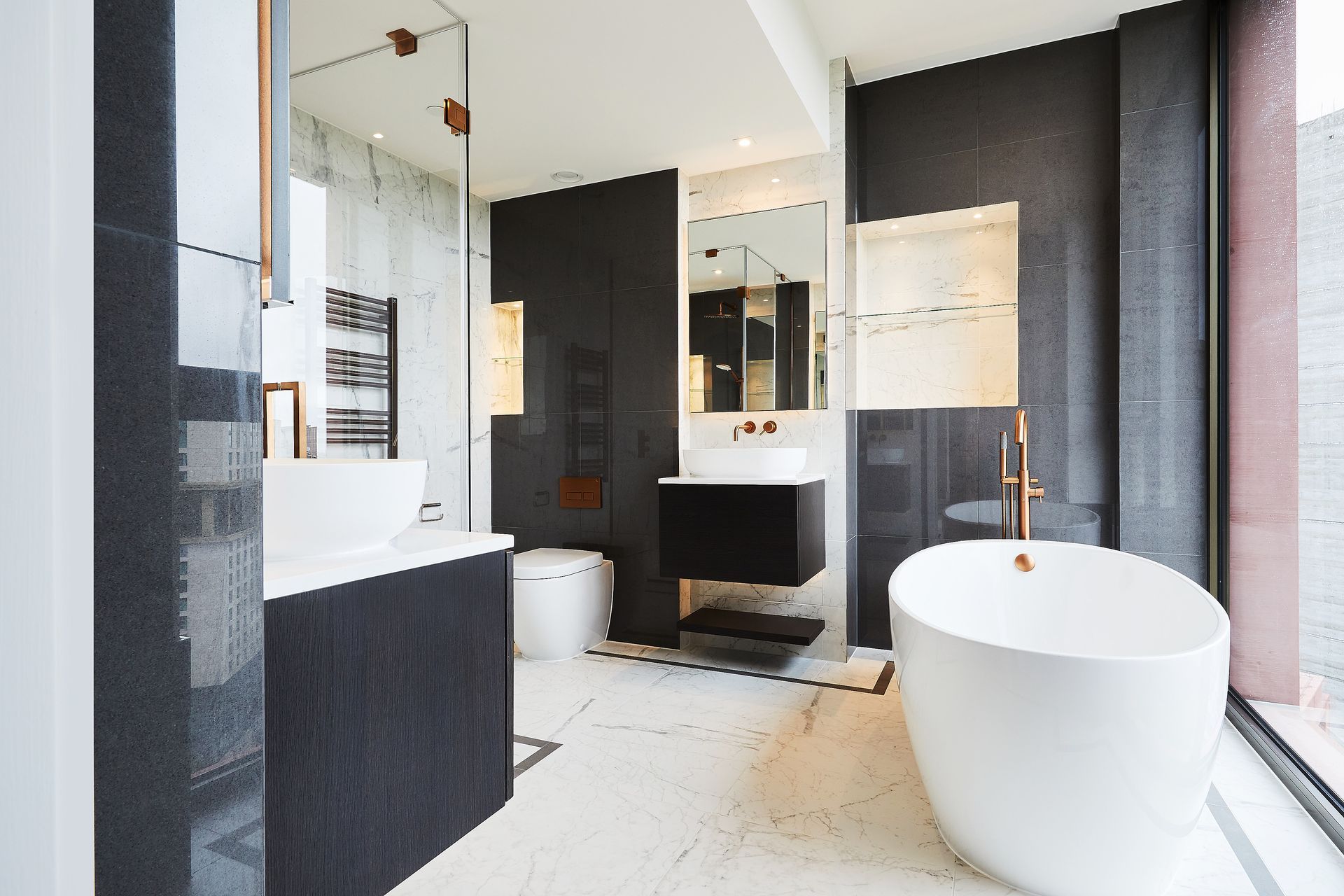Modern black-and-white bathroom with freestanding tub, double vanity, and large mirror