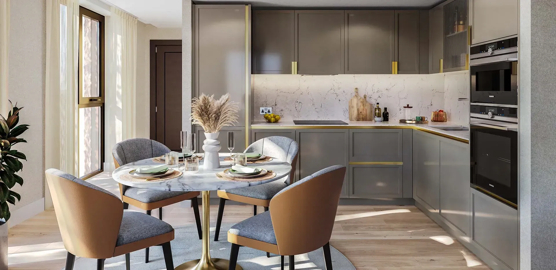 Modern kitchen-dining area with round table, tan chairs, and dark cabinets in warm natural light