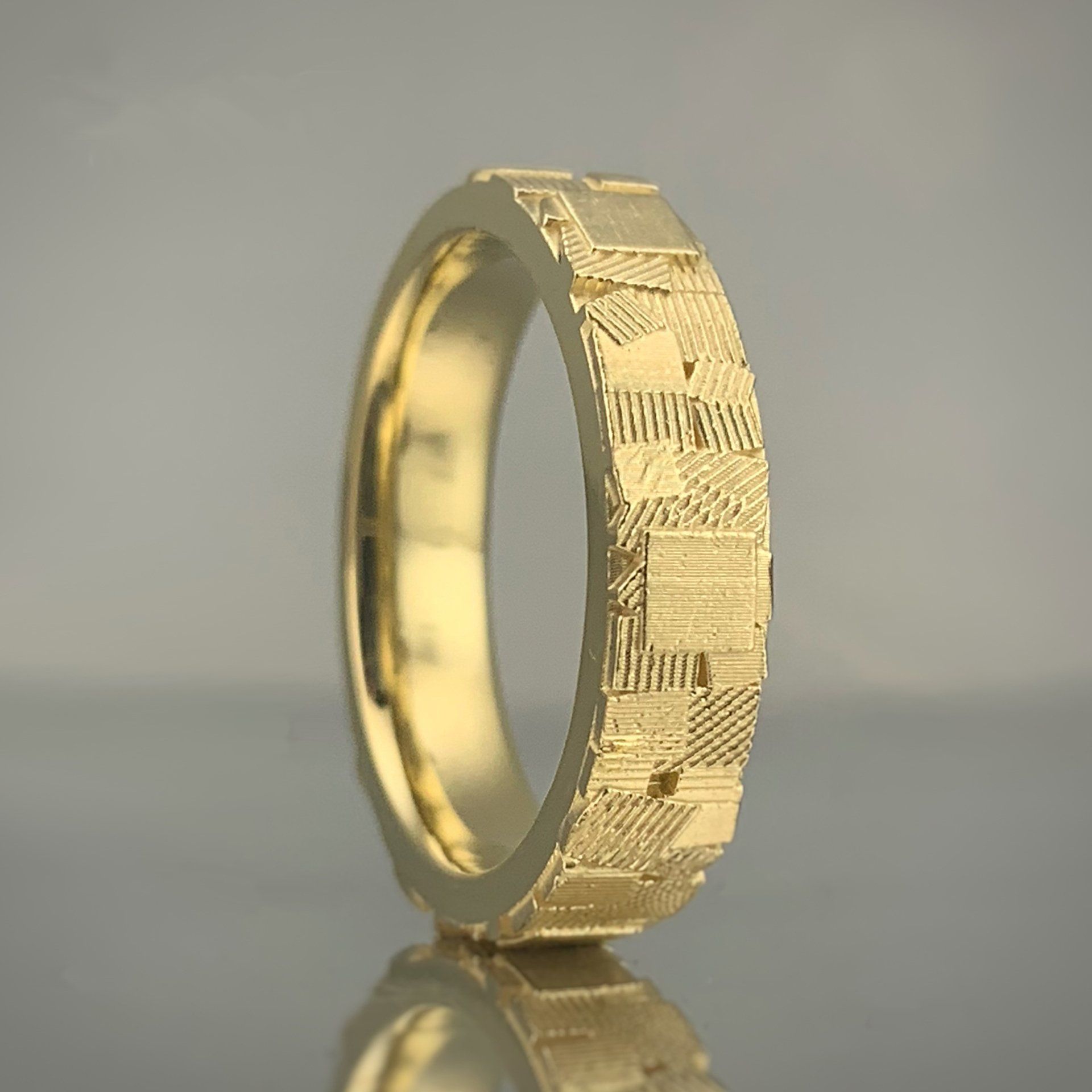 A close up of a gold ring on a table