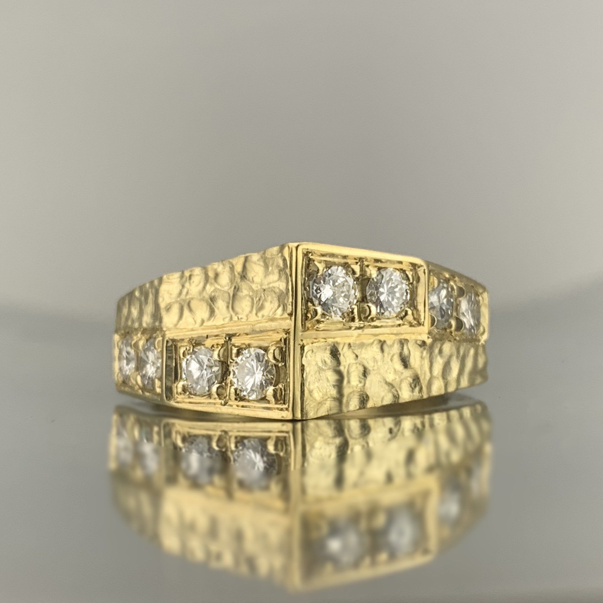 A close up of a gold ring with diamonds on it