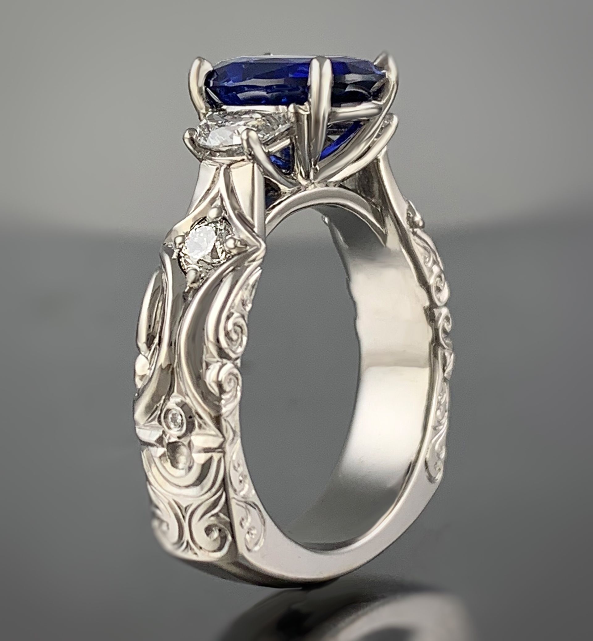 A close up of a diamond ring with a flower in the background