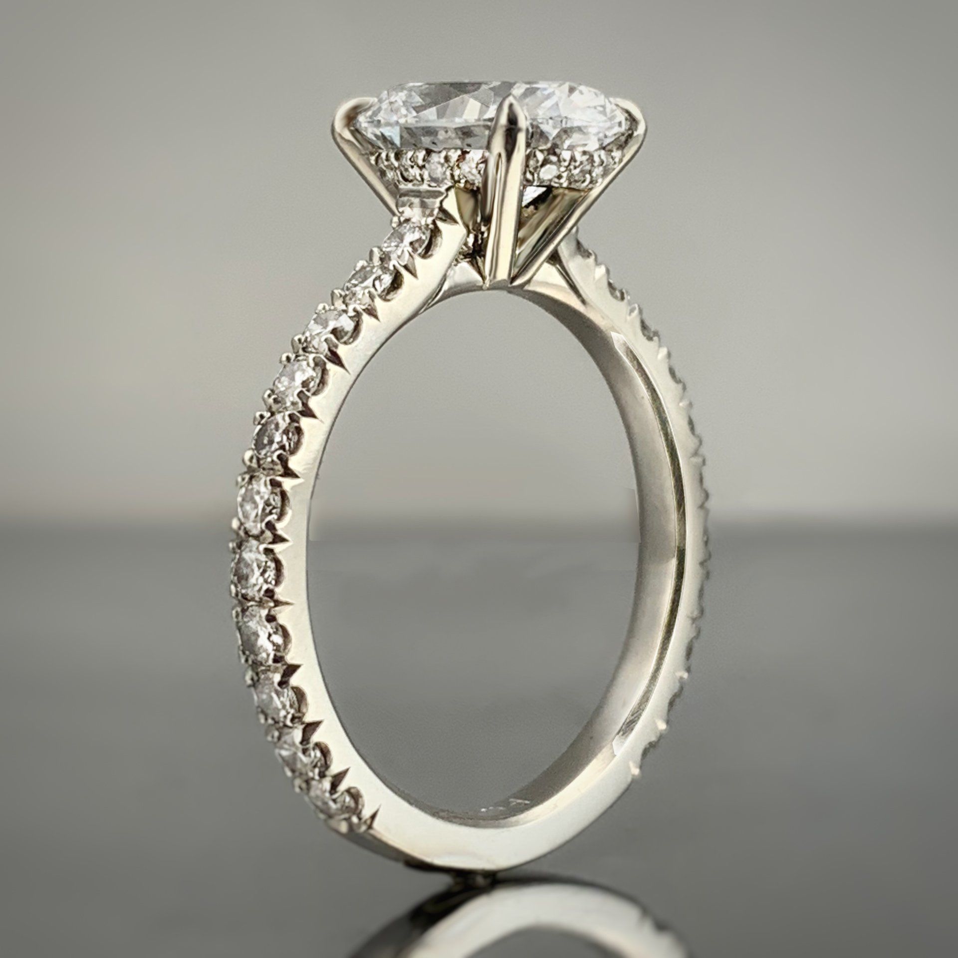 A white gold ring with a diamond in the center