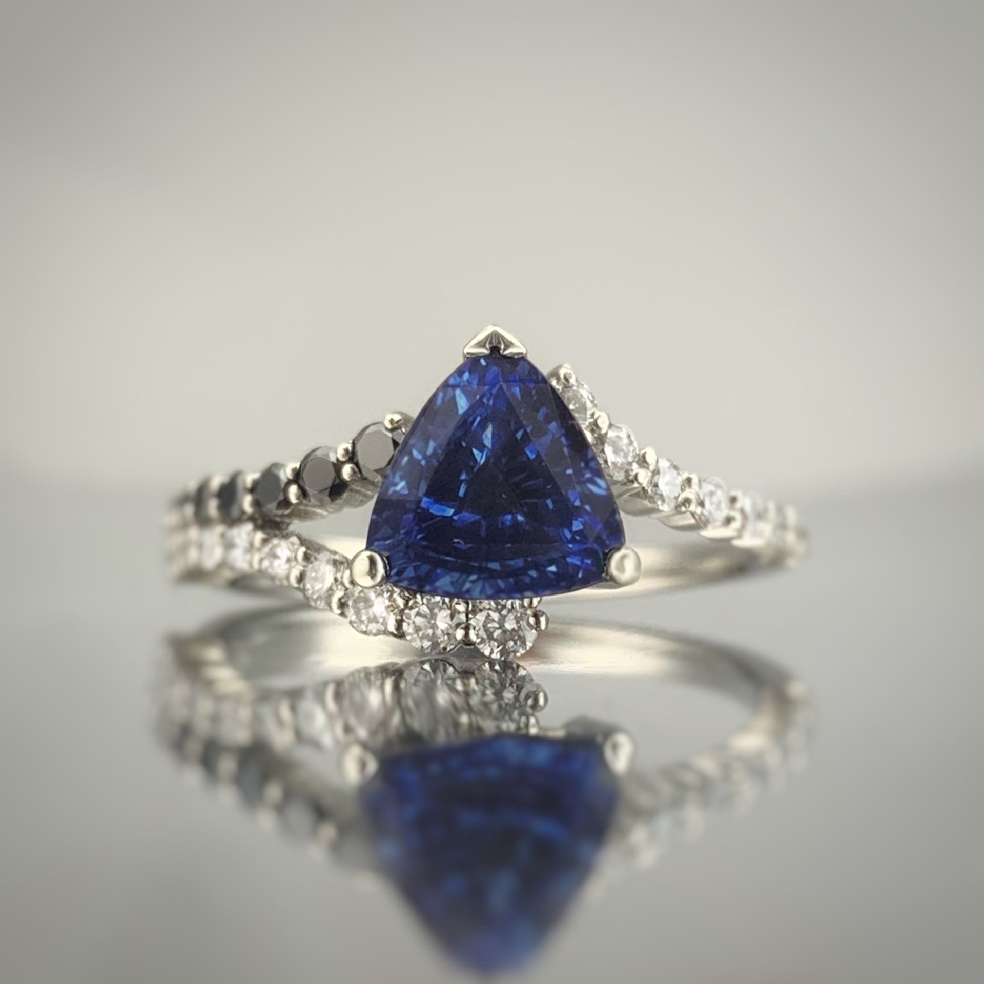A ring with a sapphire and diamonds on it