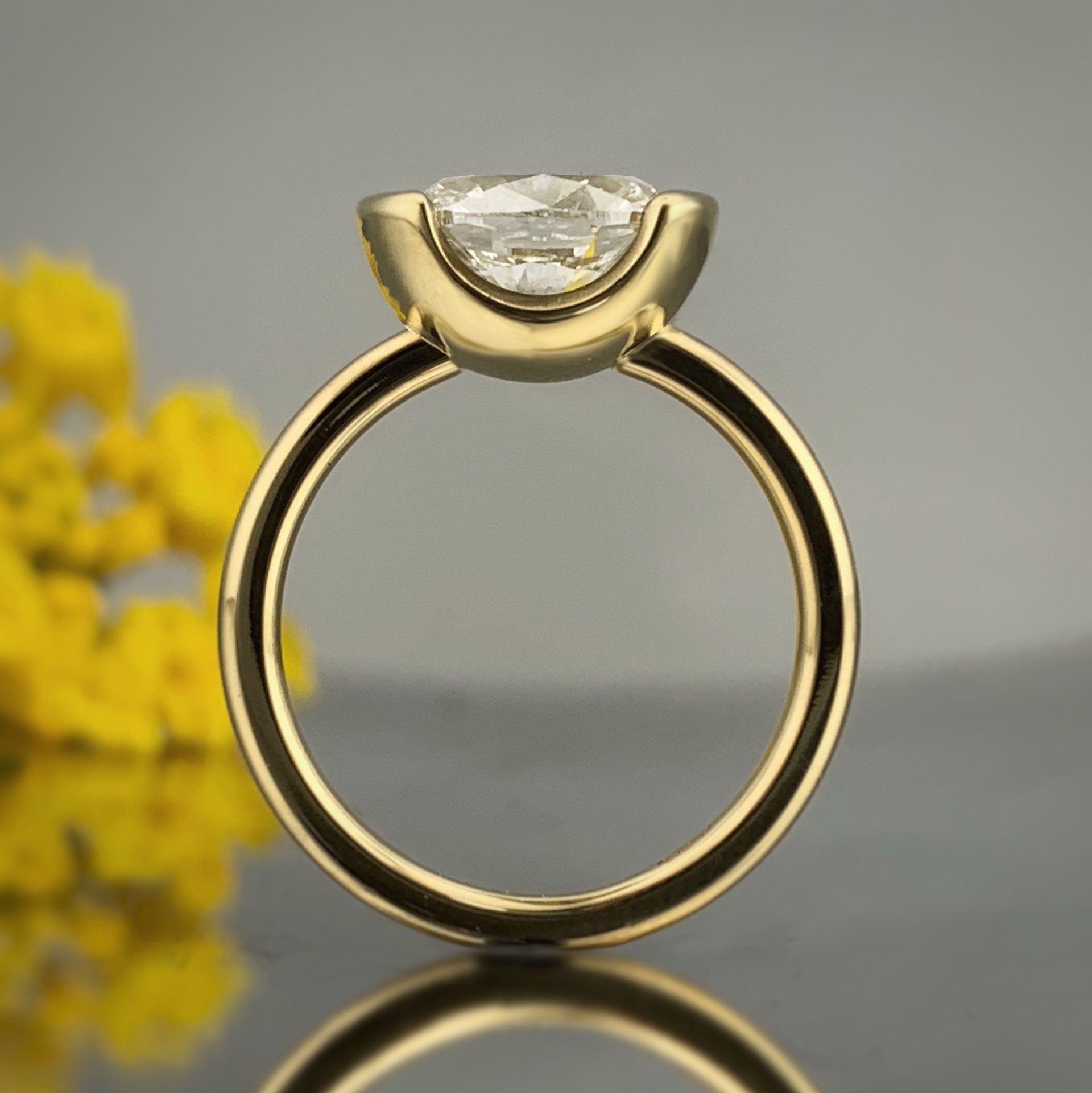 A yellow gold ring with a diamond in the center