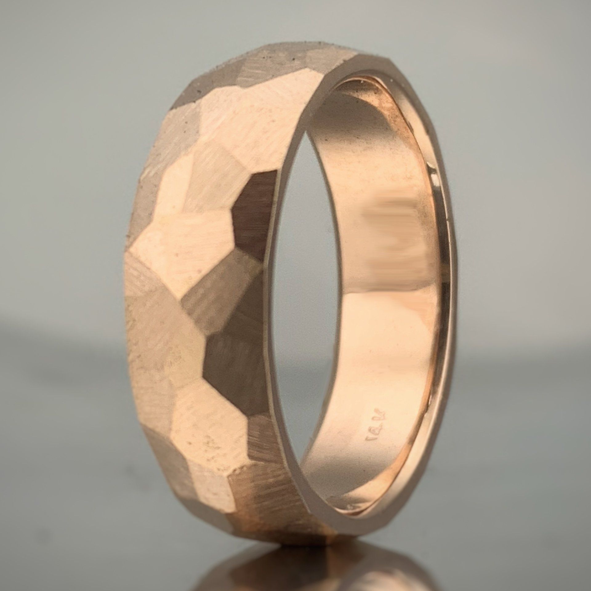 A close up of a ring that says mv on it