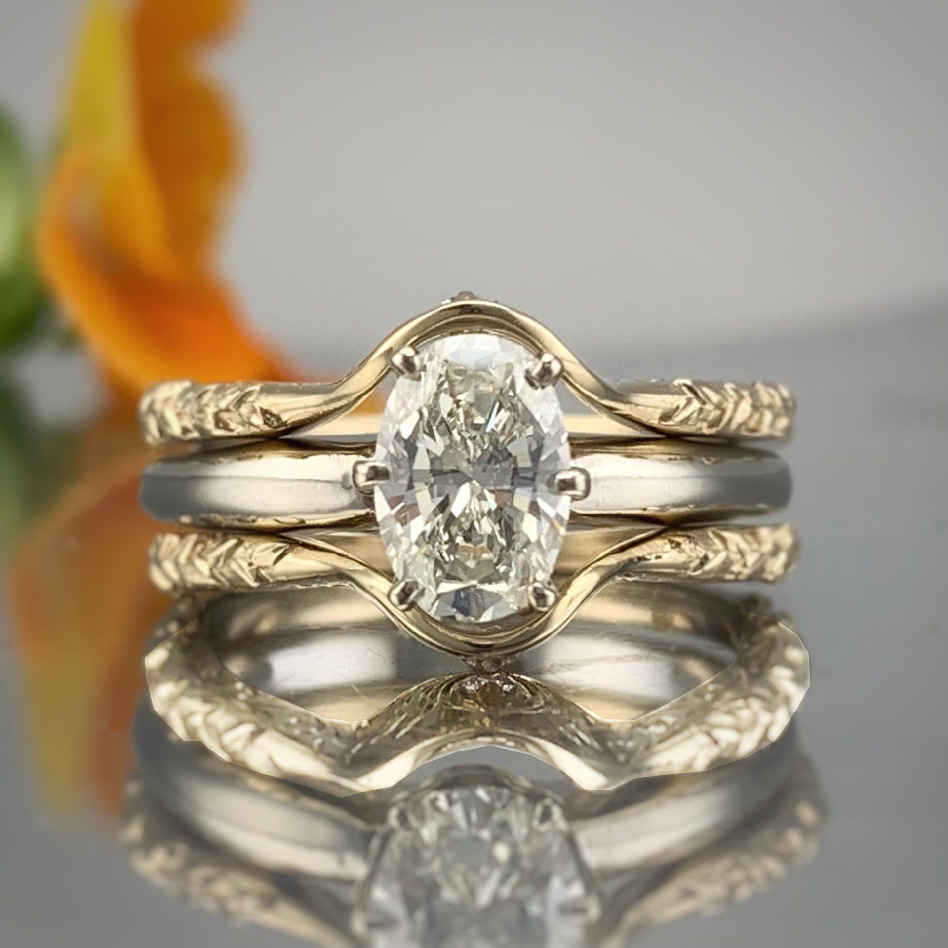 A close up of a ring with a diamond in it on a table.