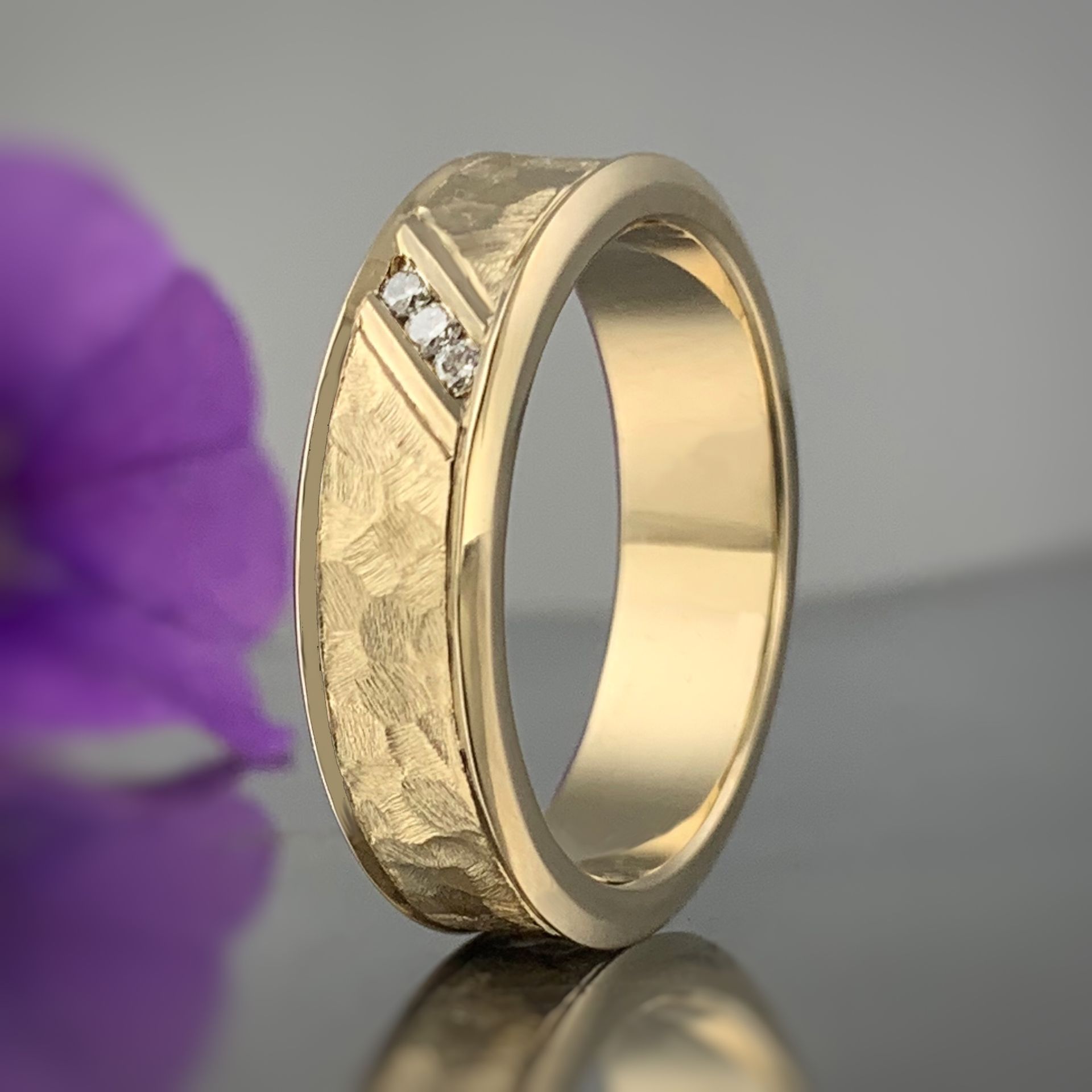 A white gold ring with a green stone and diamonds