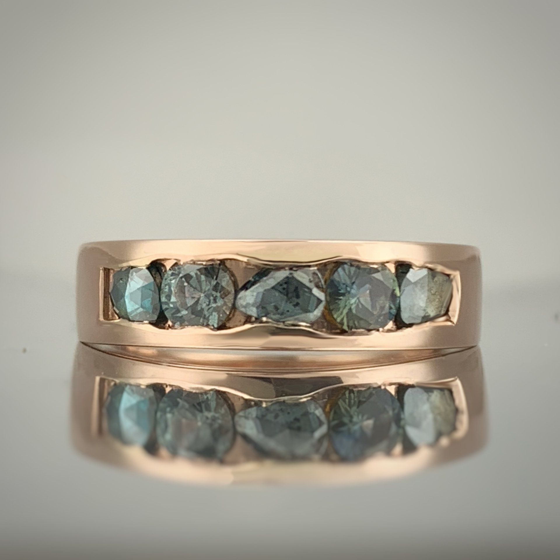 A close up of a ring with diamonds on it