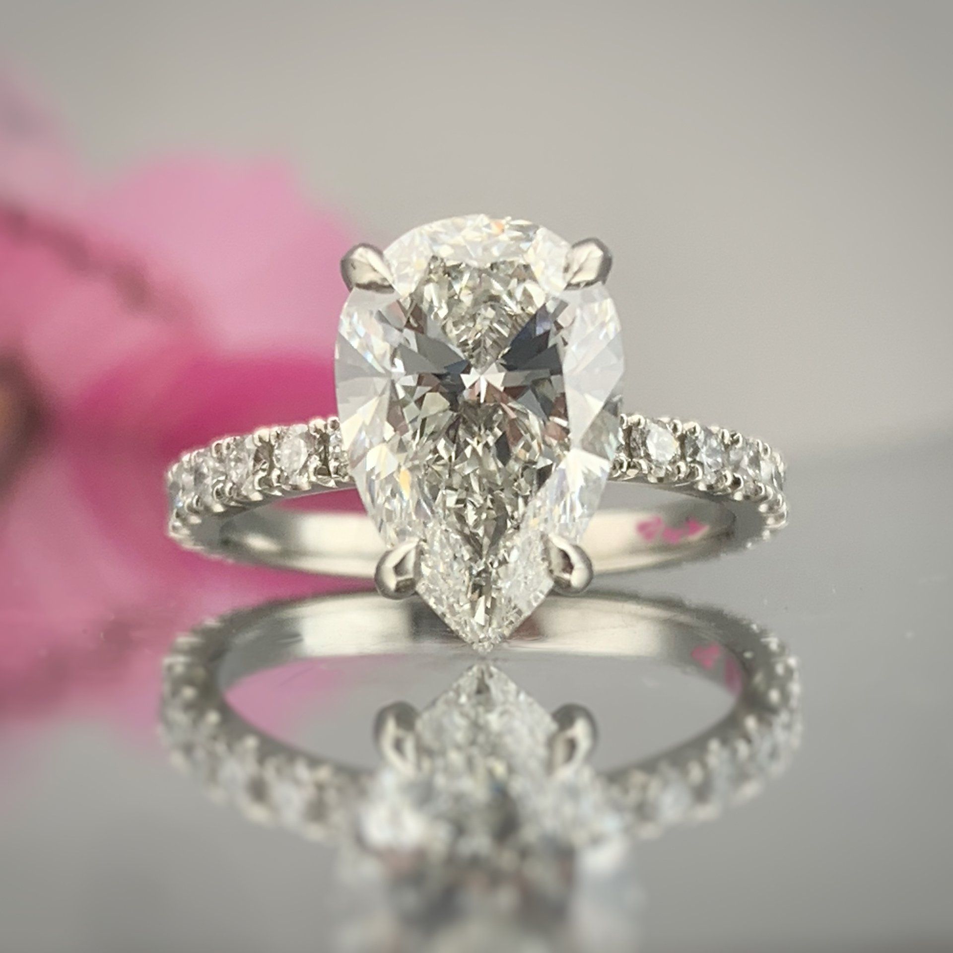 A diamond ring with a pear shaped diamond in the center