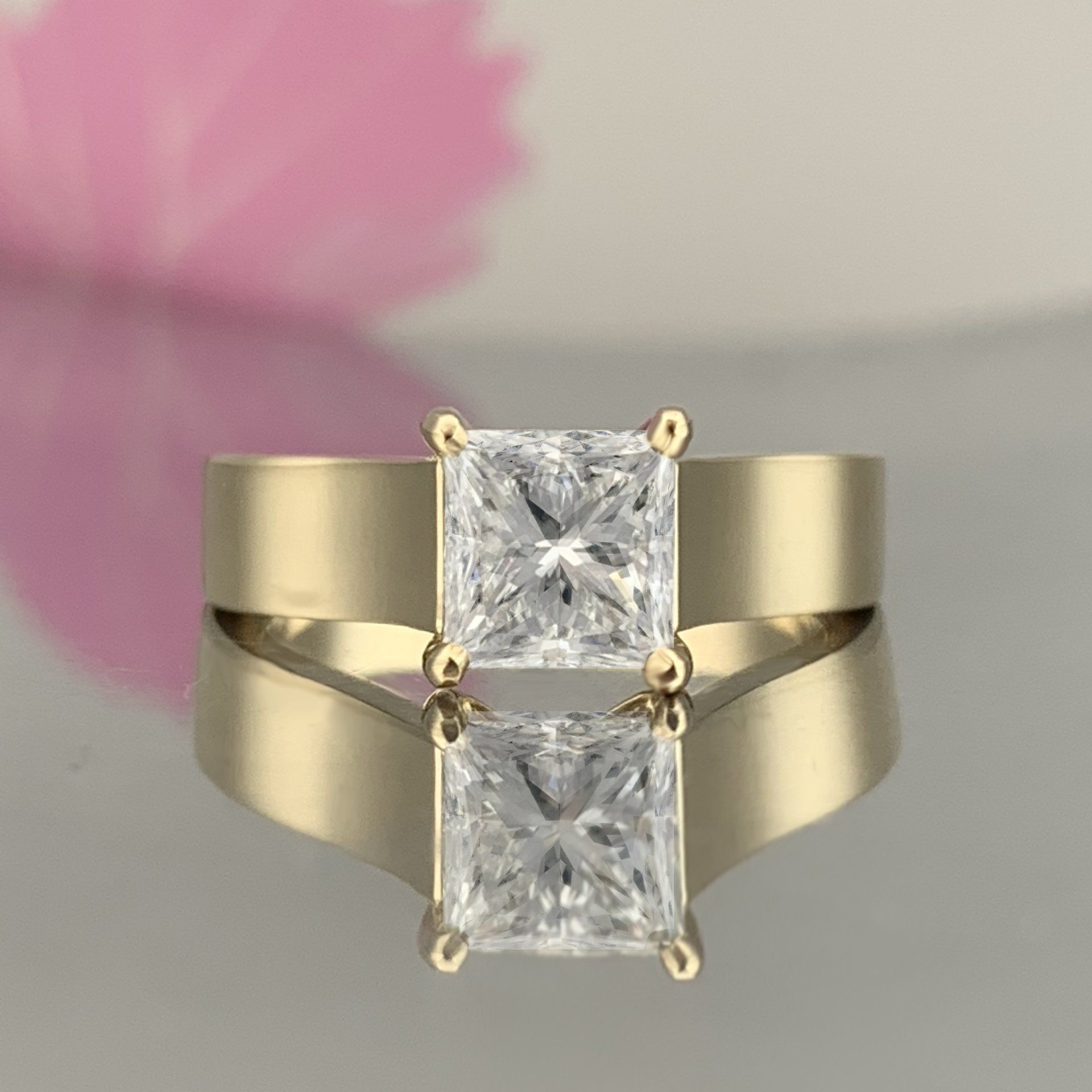 A yellow gold ring with two square diamonds on it