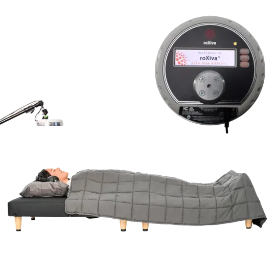 Person lying in bed under a gray blanket beside a wall-mounted round device and adjustable arm tool.