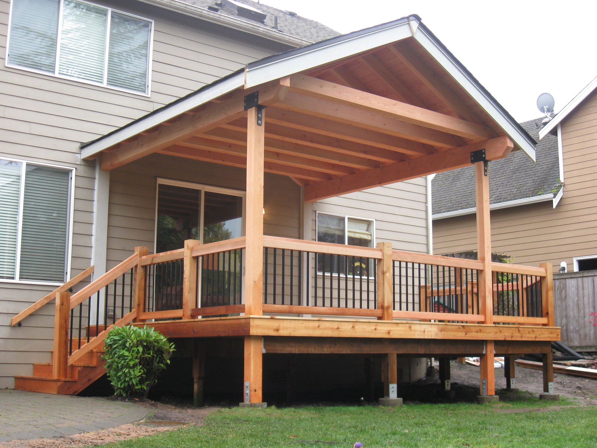 A house with a wooden deck and stairs in front of it